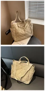 Detail of beige quilted puffer tote bag showing side pockets and soft padded texture