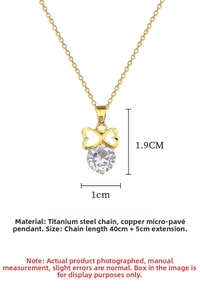Macro shot of titanium steel bow necklace pendant with white cubic zirconia inlay
