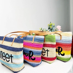 Detailed display of summer straw beach tote bags in four vibrant striped color options