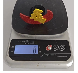 Detail shot of a Halloween DIY accessory on a digital scale weighing exactly 8 grams