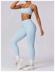 Detail of light blue yoga set with cross-back sports bra and high-waist leggings