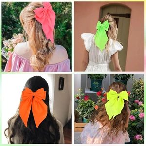 Neon oversized bow hair clips in vibrant pink green orange and yellow colors