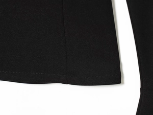 Close-up of the black elegant trousers hem showing high-quality stitching and fabric texture