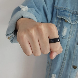 Close-up of 8mm black stainless steel ring with blue carbon fiber inlays on male hand