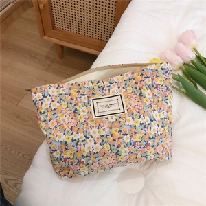 Detailed macro view of a floral cotton pouch with zipper and 'TIME TO PARTY' label