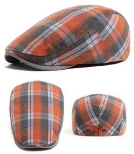Detailed close-up of plaid flat cap with orange and grey check pattern and metal buckle