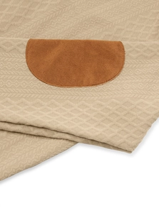 Detail of beige knitted fabric texture with brown faux suede patches on casual sweatshirt