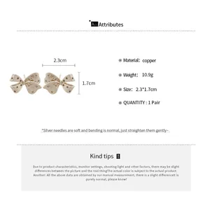 Detail showing dimensions of 2.3cm by 1.7cm for the 14K gold plated bow earrings