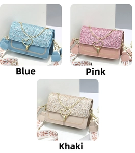 Detail view of crossbody bags in blue, pink, and khaki with sequin texture and heart clasp