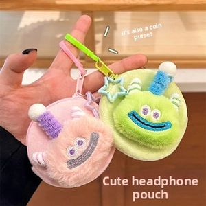 Close-up of cute plush monster headphone case and coin purse with colorful lanyards