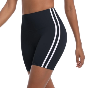 Close-up of high-waisted black yoga shorts with side stripes and elastic fabric