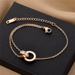 Detail of rose gold double-ring bracelet with Roman numerals and shimmering crystals
