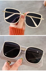 Close-up of cream square oversized sunglasses with gold metal拼接 and grey lenses