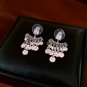 Silver needle zircon tassel earrings with shiny metal discs in a minimalist style