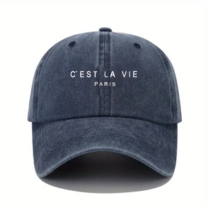 Detail showing vintage washed navy cotton fabric and white C'EST LA VIE PARIS embroidery