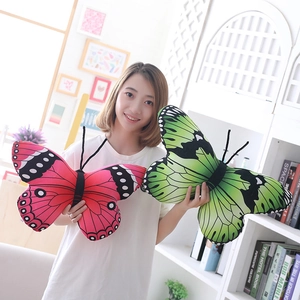 Detailed view of pink and green butterfly plush pillows with wings texture and antennae