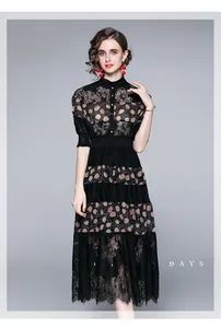 Detail of elegant black lace patchwork midi dress with stand collar and buttoned bodice