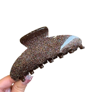 Acrylic colorful glitter hair claw clip with seven teeth in a classic minimalist shark style