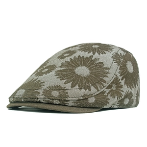Close-up of brown denim beret featuring vintage daisy floral patterns and woven texture