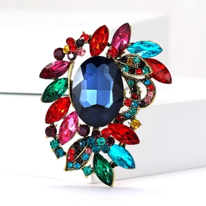 Luxury vintage bronze brooch with large oval blue gemstone and colorful crystal accents