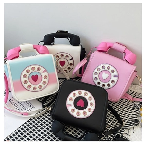 Novelty vintage telephone shaped crossbody bags in various colors and styles.