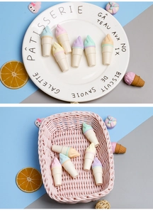 Detail showing ice cream shaped creative erasers in macaron colors on a white plate