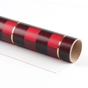 Classic red and black buffalo plaid wrapping paper roll with elegant gold line accents
