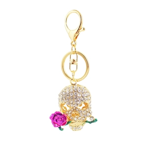 Golden skeleton keychain with crystal rhinestones holding a purple rose flower pendant