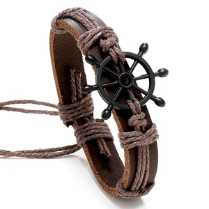 Retro braided brown leather bracelet featuring a black metal nautical rudder charm