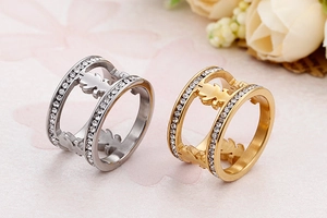 Detail of silver and gold hollow boy and girl silhouette rings with crystal inlay