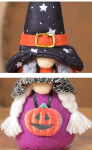 Detail of Halloween gnome dolls with star hats, orange belts and pumpkin spiderweb capes