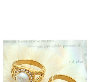 Detail of gold-plated twisted rings featuring large white pearls and zircon halos