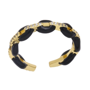 Detail of gold chain link ring with black enamel oval inlay and sparkling zircon pavé
