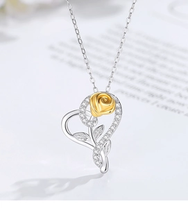Macro detail of S925 silver heart necklace featuring a golden rose and sparkling crystals