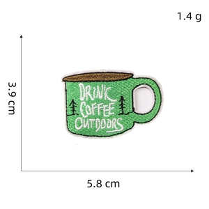 Detailed embroidery patch showing a green coffee mug with outdoor forest and trees