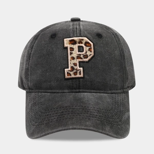 Close-up of washed denim baseball cap with leopard print letter P embroidery