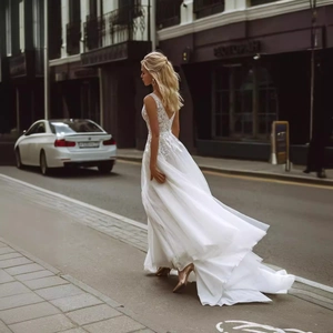 Elegant white French-style bridal gown with lace embroidery and long tulle train