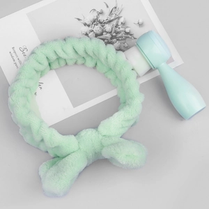 Detail of soft plush headband and silicone face brush set for daily skincare routine