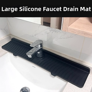 Detailed view of black silicone faucet drip mat with sloped drainage ridges for kitchen sink