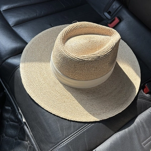 Close-up of high-quality raffia sun hat texture with natural straw weave and ribbon