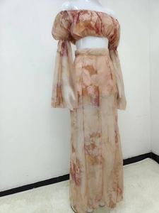 Detail of floral two-piece set with off-shoulder puff sleeve top and split maxi skirt