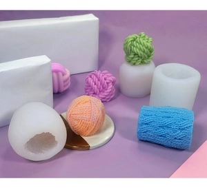 Macro detail of ball of yarn silicone mold with colorful handmade candle crafts