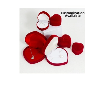 Detailed view of red heart-shaped velvet jewelry boxes for rings and necklaces