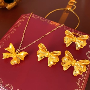 Exquisite 18K gold butterfly jewelry set featuring matte hollow design earrings and necklace