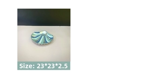 Detail view of shell-shaped jewelry display tray in teal stripes, size 23x23x2.5 cm