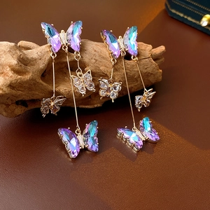 Detail of butterfly tassel earrings with purple-blue gradients and sparkling zircons