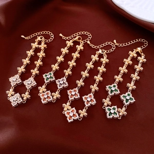 Detail of 18K gold-plated floral bracelets with colorful zircon stones on silk