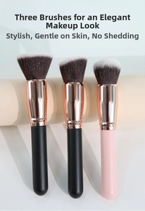 Detail view of three foundation brushes with dense bristles and rose gold metal tubes