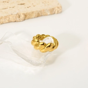 Polished 18K gold croissant twisted ring displayed on crystal for a vintage chic look