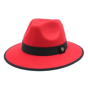 Classic red wool fedora jazz hat with black band and gold M logo buckle on white background